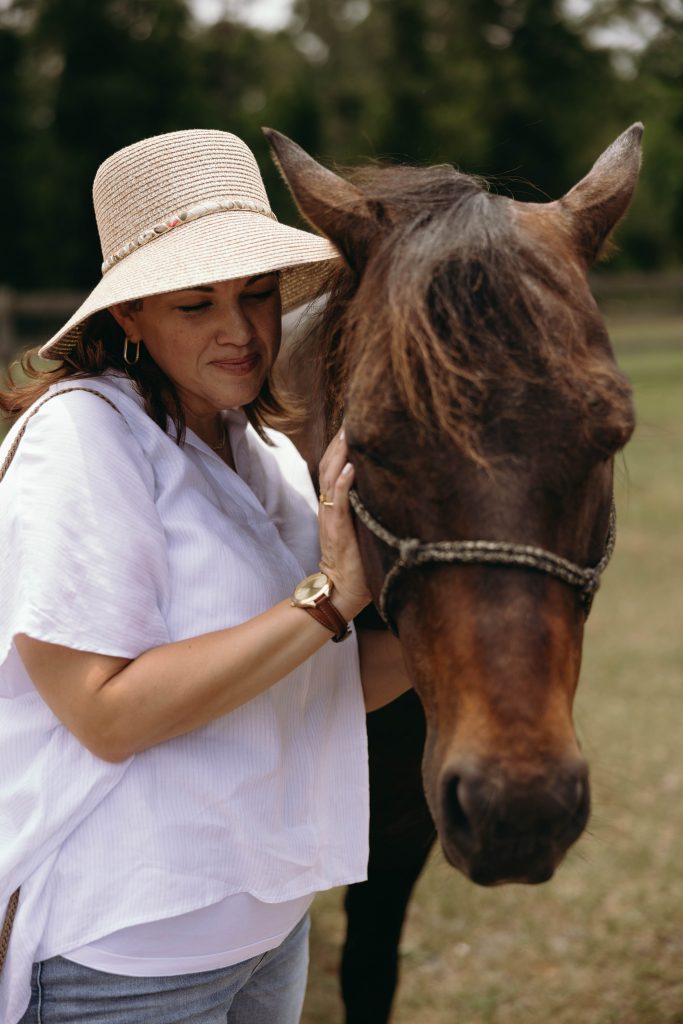 Jennifer Sierra, holistic mental health counselor at HMH Counseling, with Tuck, A horse at First Nature Ranch, highlighting her commitment to nature-inspired wellness and community involvement in Orlando, FL